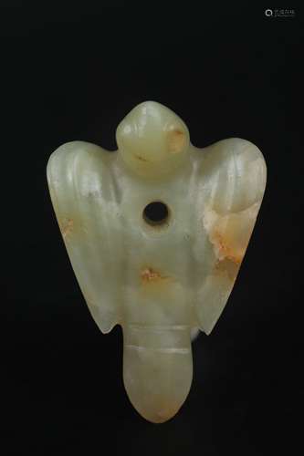 A CARVED CELADON JADE BIRD