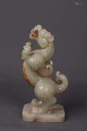 A CARVED HETIAN JADE ORNAMENT OF BEAST