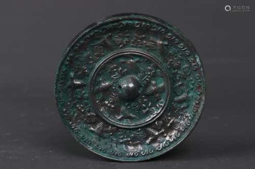 A BRONZE BIRD ROUND MIRROR