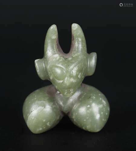 A CARVED CELADON JADE BEAST ORNAMENT