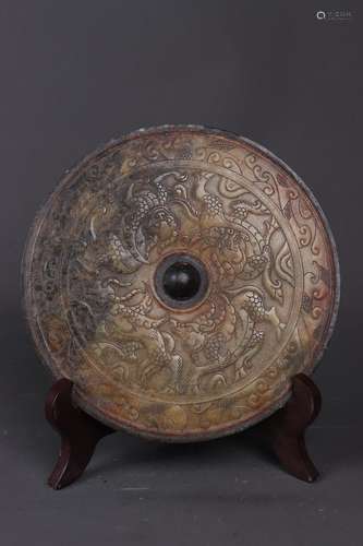 A RELIEF-DECORATED BROWNISH JADE BEAST MIRROR