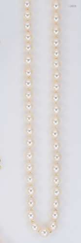 A single row of cultured freshwater pearls and pearl ear stu...