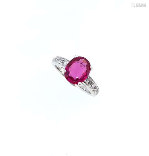 An oval rubellite ring with diamond set shoulders,