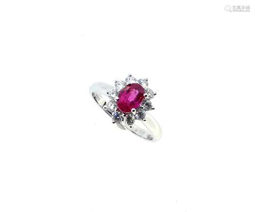 An 18ct gold ruby and diamond oval cluster ring,