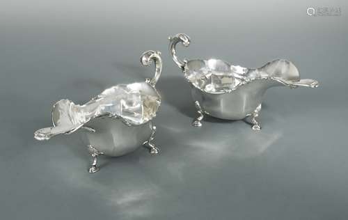 A near pair of George V silver sauce boats with earlier ladl...