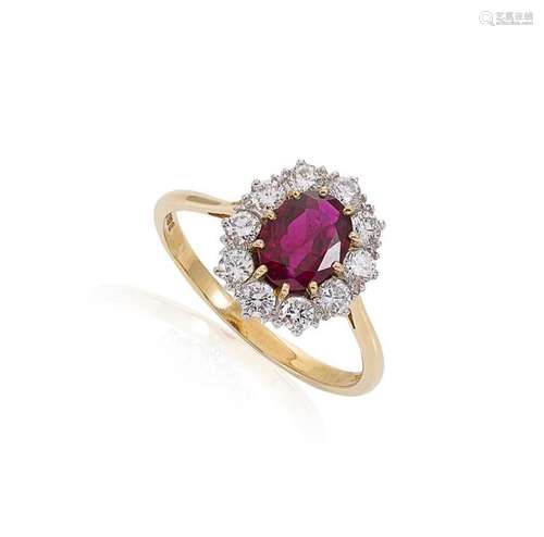 A ruby and diamond cluster ring set in 18ct gold,