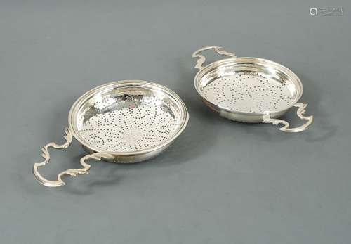 A George III 18th century silver lemon strainer and another,