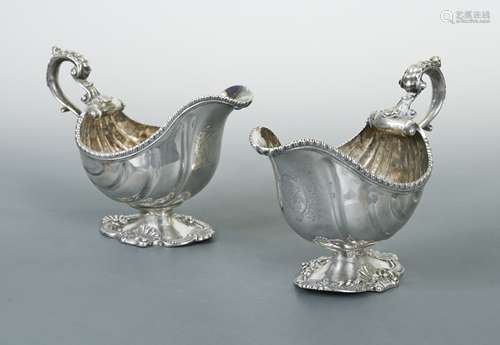 A near pair of Georgian 18th century cast silver sauce boats...