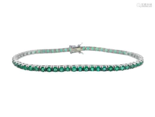 An emerald line bracelet set in 18ct white gold,
