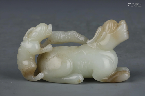 A CHINESE WHITE JADE CARVED AUSPICIOUS BEAST ORNA…