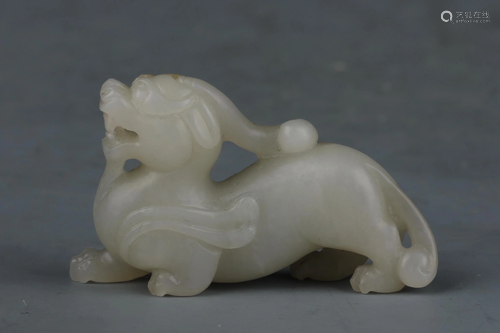 A CHINESE WHITE JADE CARVED AUSPICIOUS BEAST ORNA…