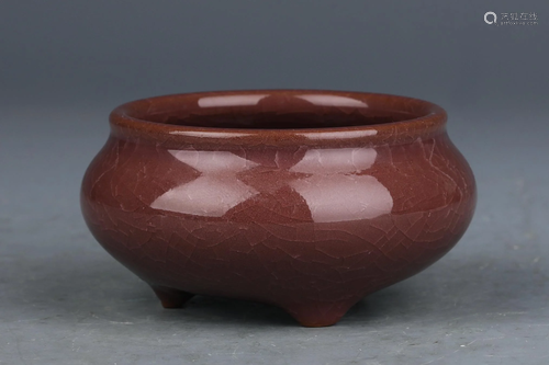 A CHINESE RED GLAZED PORCELAIN TRIPOD CENSER