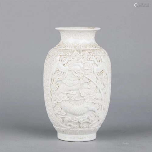 A CHINESE CARVED PORCELAIN VASE