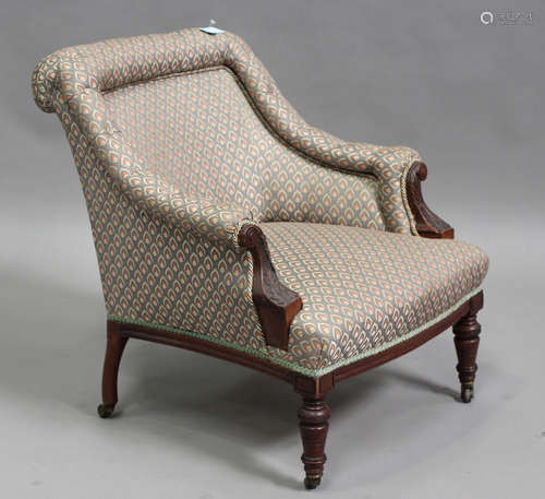 An Edwardian walnut framed tub back armchair with carved dec...