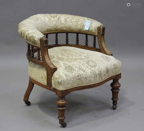 A late Victorian walnut framed tub back salon chair, raised ...