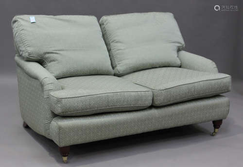 A modern Howard style two-seat sofa, upholstered in green pa...