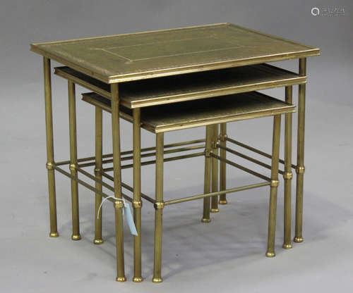 A mid-20th century gilt brass nest of three occasional table...