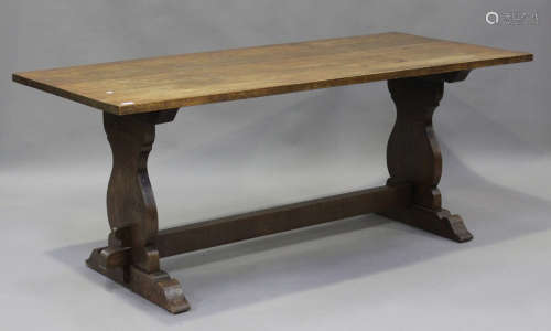 A 20th century oak refectory table, the rectangular top rais...