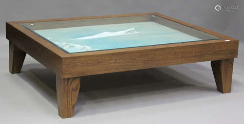 A modern oak framed coffee table, the glazed top inset with ...