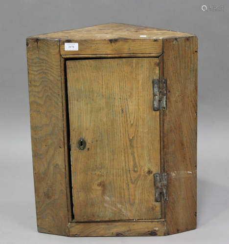 An 18th century primitive elm hanging corner cabinet, height...