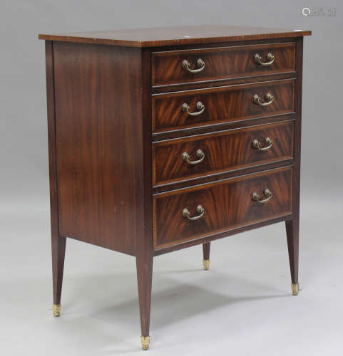 A modern reproduction mahogany chest of four long drawers by...