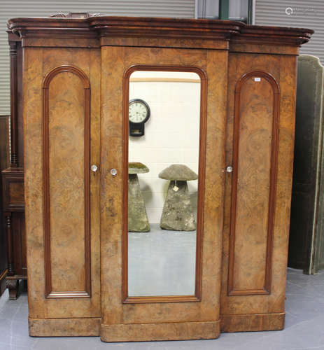 A mid-Victorian burr walnut three-section wardrobe, the cent...