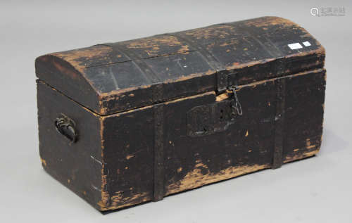 A 19th century black painted pine domed top trunk with carry...