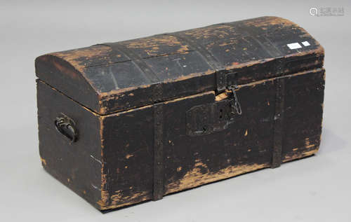 A 19th century black painted pine domed top trunk with carry...