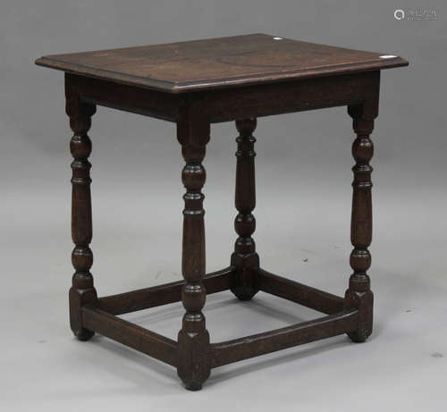 An 18th century oak centre table, on turned and block legs u...