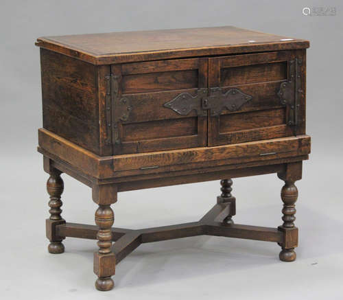 An early 20th century oak chest-on-stand, the hinged lid and...