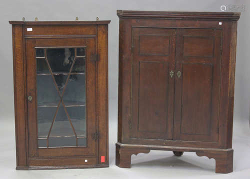 A George III oak hanging corner display cabinet, height 122c...