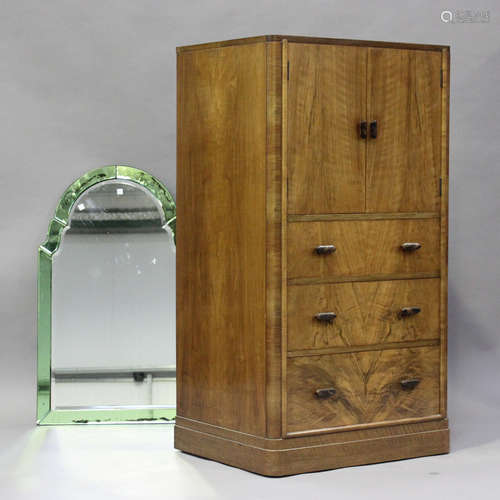 An Art Deco walnut tallboy, fitted with a cupboard above thr...