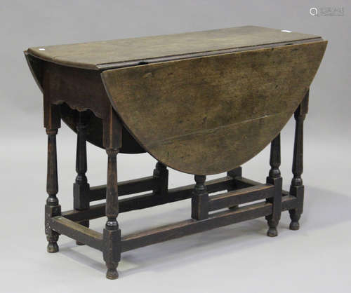 An 18th century oak oval gateleg table, on turned and block ...