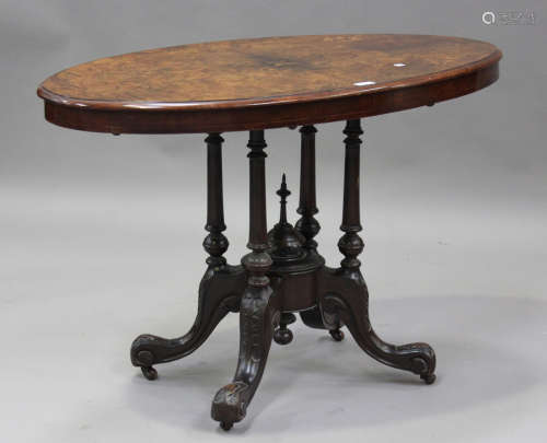 A late Victorian walnut oval centre table with inlaid decora...