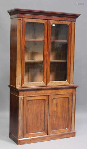 A Victorian mahogany bookcase cabinet, the moulded pediment ...