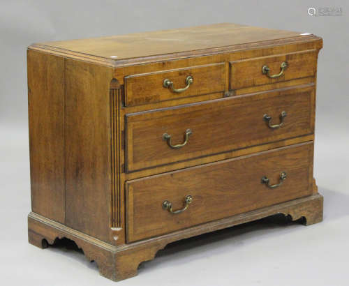 A George III oak chest of two short and two long drawers, on...