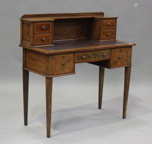 An Edwardian walnut and satinwood crossbanded writing table,...