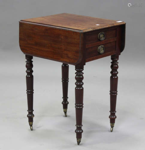 A 19th century mahogany drop-flap work table, on turned legs...
