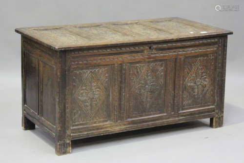 A late 17th century panelled oak coffer with later carved de...