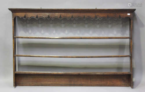 An 18th century oak hanging plate rack, the pierced frieze a...