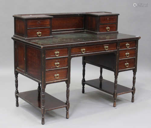 A late Victorian stained walnut writing desk by Gillow & Co,...