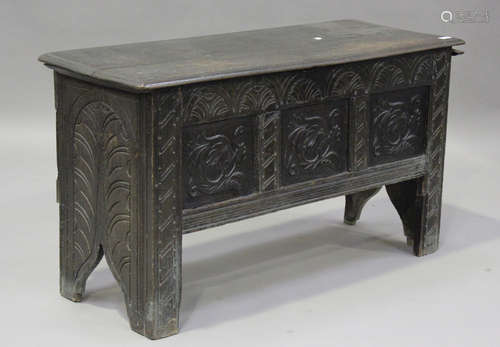 An 18th century oak coffer, the hinged lid above a later car...