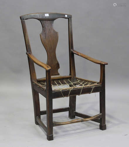 A George III provincial ash splat back elbow chair with rope...