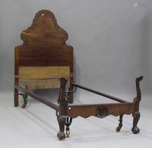 A George V mahogany single bed frame with carved decoration,...