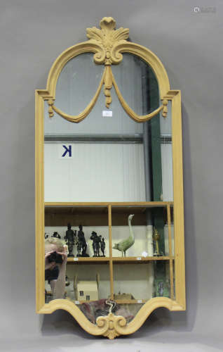 A late 20th century pine framed pier mirror with leaf and sw...