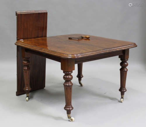 A late Victorian mahogany extending dining table with single...