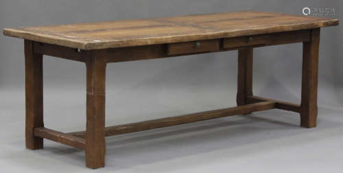 A 20th century oak refectory table, raised on chamfered bloc...