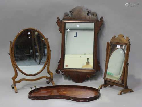 A 20th century Queen Anne style walnut swing frame mirror, a...
