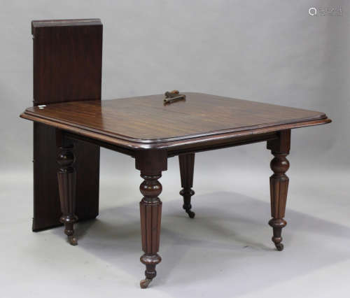 A Victorian mahogany extending dining table with single extr...