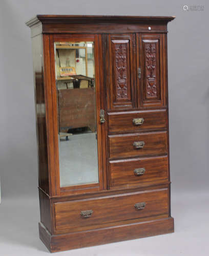 An Edwardian walnut wardrobe with carved decoration, fitted ...